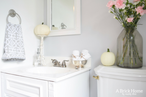 This powder room makeover REVEAL is insane! I can't believe how little money she spent to completely transform this powder room to a light and bright one. These small powder room ideas are must-see's!