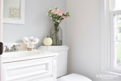 This powder room makeover REVEAL is insane! I can't believe how little money she spent to completely transform this powder room to a light and bright one. These small powder room ideas are must-see's!
