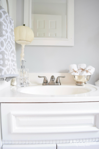 This powder room makeover REVEAL is insane! I can't believe how little money she spent to completely transform this powder room to a light and bright one. These small powder room ideas are must-see's!