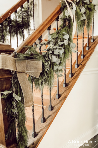 Obsessing over this DIY Christmas Garland! Learn how to make DIY Christmas Garland Using Simple Faux Garland and Real Pine Branches! #abrickhome #garland