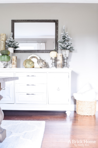 Gorgeous Dining Room Decked out in Transitional Fall to Winter Holiday Decor! A snowy tablescape with evergreens and pumpkins top off the almost Christmas decor look! #falldecor #winterdecor