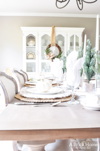 Gorgeous Dining Room Decked out in Transitional Fall to Winter Holiday Decor! A snowy tablescape with evergreens and pumpkins top off the almost Christmas decor look! #falldecor #winterdecor