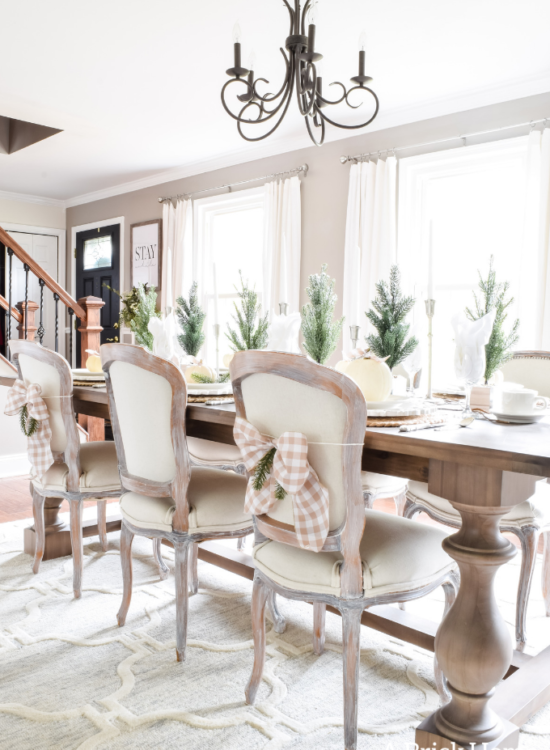 Gorgeous Dining Room Decked out in Transitional Fall to Winter Holiday Decor! A snowy tablescape with evergreens and pumpkins top off the almost Christmas decor look! #falldecor #winterdecor
