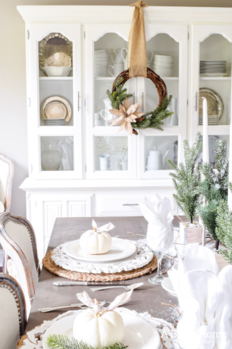 Gorgeous Dining Room Decked out in Transitional Fall to Winter Holiday Decor! A snowy tablescape with evergreens and pumpkins top off the almost Christmas decor look! #falldecor #winterdecor