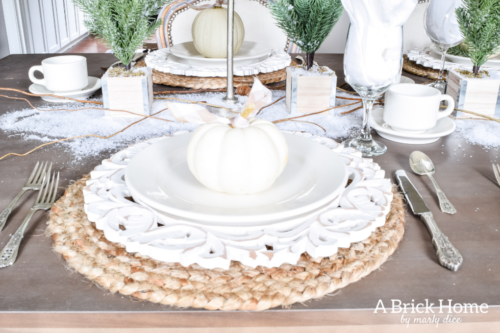 Gorgeous Dining Room Decked out in Transitional Fall to Winter Holiday Decor! A snowy tablescape with evergreens and pumpkins top off the almost Christmas decor look! #falldecor #winterdecor