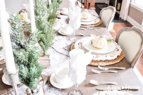 Gorgeous Dining Room Decked out in Transitional Fall to Winter Holiday Decor! A snowy tablescape with evergreens and pumpkins top off the almost Christmas decor look! #falldecor #winterdecor