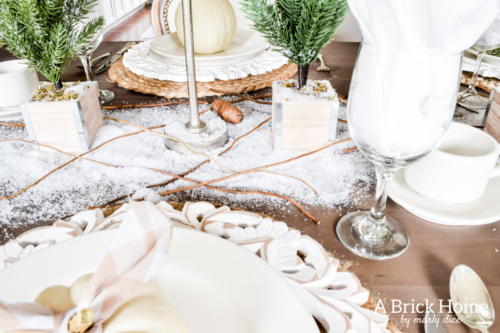 Gorgeous Dining Room Decked out in Transitional Fall to Winter Holiday Decor! A snowy tablescape with evergreens and pumpkins top off the almost Christmas decor look! #falldecor #winterdecor