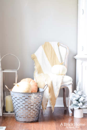 Gorgeous Dining Room Decked out in Transitional Fall to Winter Holiday Decor! A snowy tablescape with evergreens and pumpkins top off the almost Christmas decor look! #falldecor #winterdecor