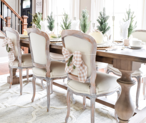 Gorgeous Dining Room Decked out in Transitional Fall to Winter Holiday Decor! A snowy tablescape with evergreens and pumpkins top off the almost Christmas decor look! #falldecor #winterdecor