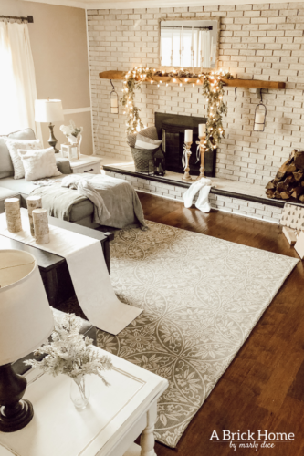 This gorgeous neutral Christmas mantel accompanies a cozy and neutral family room with a snow-filled Christmas tree! Take the whole tour NOW! Tons of inspiration!! #christmasmantel