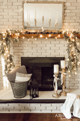 This gorgeous neutral Christmas mantel accompanies a cozy and neutral family room with a snow-filled Christmas tree! Take the whole tour NOW! Tons of inspiration!! #christmasmantel