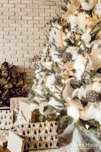 This Snowy white Christmas tree is both rustic and elegant. I CAN'T BELIEVE what she used for the snow on the tree! #christmastreedecor