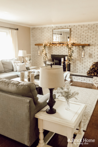 This gorgeous neutral Christmas mantel accompanies a cozy and neutral family room with a snow-filled Christmas tree! Take the whole tour NOW! Tons of inspiration!! #christmasmantel