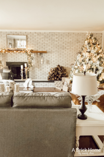 This Snowy white Christmas tree is both rustic and elegant. I CAN'T BELIEVE what she used for the snow on the tree! #christmastreedecor