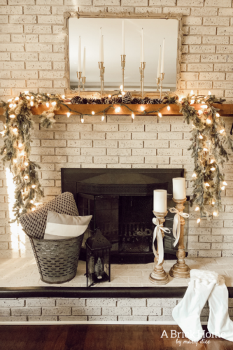 This gorgeous neutral Christmas mantel accompanies a cozy and neutral family room with a snow-filled Christmas tree! Take the whole tour NOW! Tons of inspiration!! #christmasmantel
