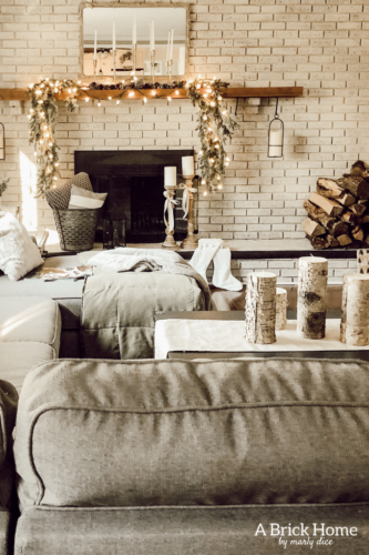 This gorgeous neutral Christmas mantel accompanies a cozy and neutral family room with a snow-filled Christmas tree! Take the whole tour NOW! Tons of inspiration!! #christmasmantel