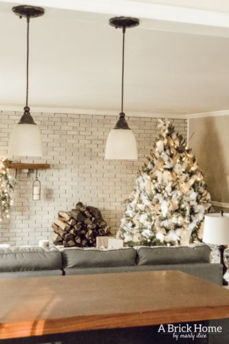 This Snowy white Christmas tree is both rustic and elegant. I CAN'T BELIEVE what she used for the snow on the tree! #christmastreedecor