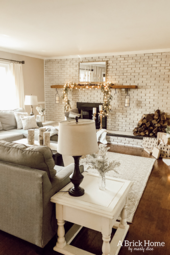 This gorgeous neutral Christmas mantel accompanies a cozy and neutral family room with a snow-filled Christmas tree! Take the whole tour NOW! Tons of inspiration!! #christmasmantel