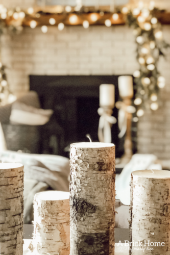 This gorgeous neutral Christmas mantel accompanies a cozy and neutral family room with a snow-filled Christmas tree! Take the whole tour NOW! Tons of inspiration!! #christmasmantel