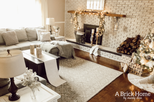 This gorgeous neutral Christmas mantel accompanies a cozy and neutral family room with a snow-filled Christmas tree! Take the whole tour NOW! Tons of inspiration!! #christmasmantel