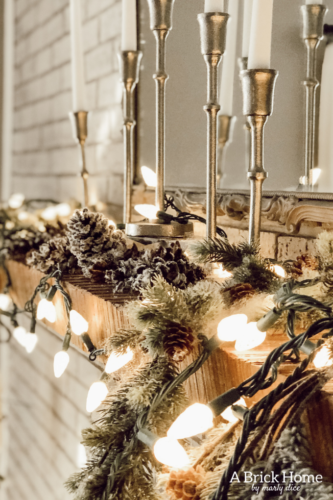This gorgeous neutral Christmas mantel accompanies a cozy and neutral family room with a snow-filled Christmas tree! Take the whole tour NOW! Tons of inspiration!! #christmasmantel