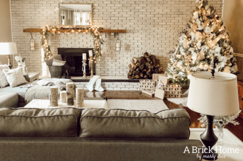 This gorgeous neutral Christmas mantel accompanies a cozy and neutral family room with a snow-filled Christmas tree! Take the whole tour NOW! Tons of inspiration!! #christmasmantel