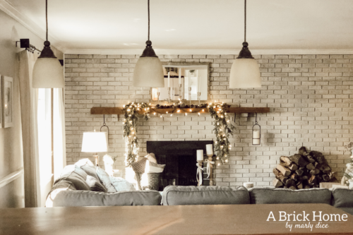 This gorgeous neutral Christmas mantel accompanies a cozy and neutral family room with a snow-filled Christmas tree! Take the whole tour NOW! Tons of inspiration!! #christmasmantel