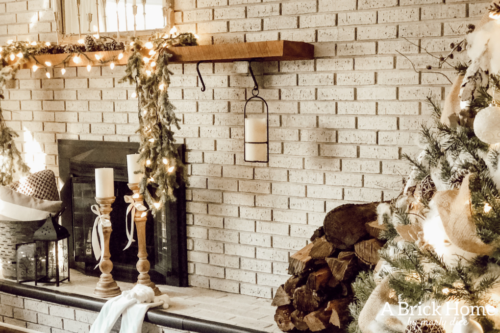 This gorgeous neutral Christmas mantel accompanies a cozy and neutral family room with a snow-filled Christmas tree! Take the whole tour NOW! Tons of inspiration!! #christmasmantel