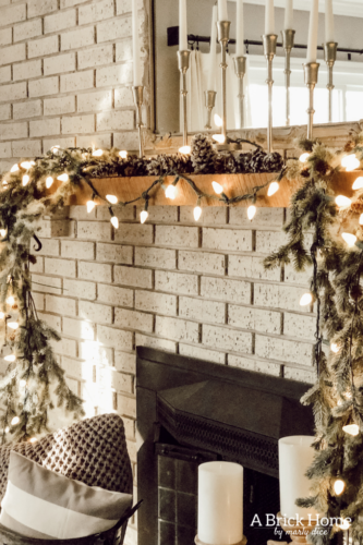 This gorgeous neutral Christmas mantel accompanies a cozy and neutral family room with a snow-filled Christmas tree! Take the whole tour NOW! Tons of inspiration!! #christmasmantel
