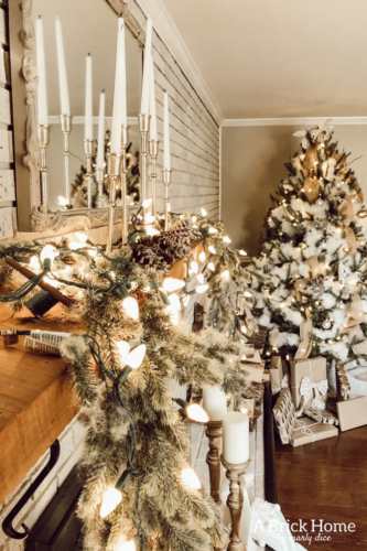 This gorgeous neutral Christmas mantel accompanies a cozy and neutral family room with a snow-filled Christmas tree! Take the whole tour NOW! Tons of inspiration!! #christmasmantel