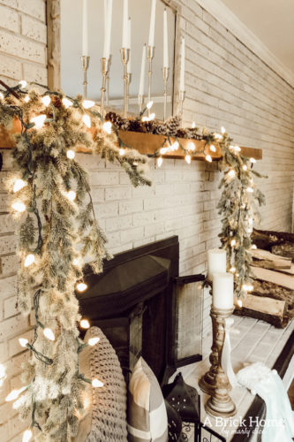 This gorgeous neutral Christmas mantel accompanies a cozy and neutral family room with a snow-filled Christmas tree! Take the whole tour NOW! Tons of inspiration!! #christmasmantel