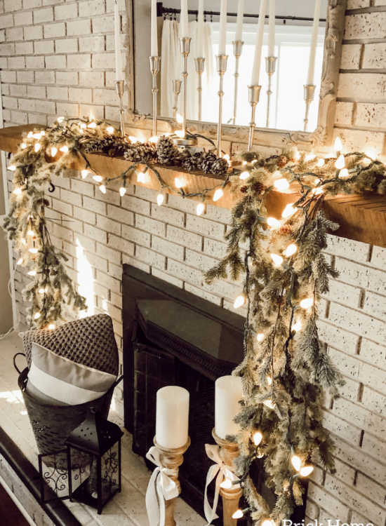 This gorgeous neutral Christmas mantel accompanies a cozy and neutral family room with a snow-filled Christmas tree! Take the whole tour NOW! Tons of inspiration!! #christmasmantel