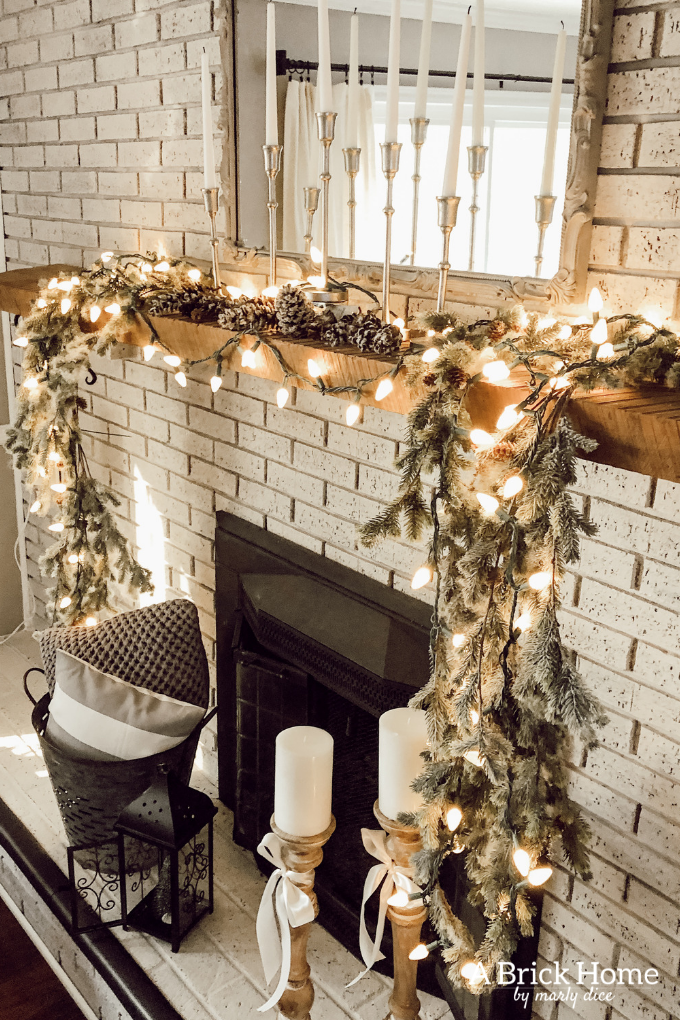This gorgeous neutral Christmas mantel accompanies a cozy and neutral family room with a snow-filled Christmas tree! Take the whole tour NOW! Tons of inspiration!! #christmasmantel