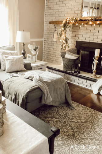 This gorgeous neutral Christmas mantel accompanies a cozy and neutral family room with a snow-filled Christmas tree! Take the whole tour NOW! Tons of inspiration!! #christmasmantel