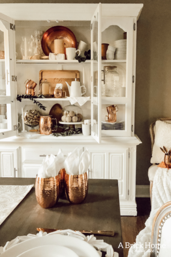 LOVING these COPPER decor accents right now. Perfect for winter and paired with wood tones. See how Marly decorates her dining room with copper. #copperdecor
