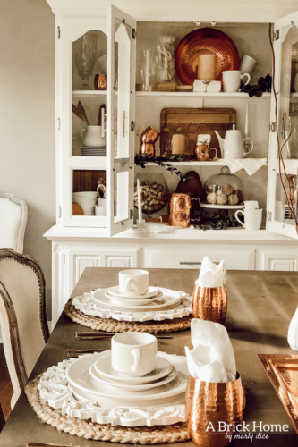 LOVING these COPPER decor accents right now. Perfect for winter and paired with wood tones. See how Marly decorates her dining room with copper. #copperdecor