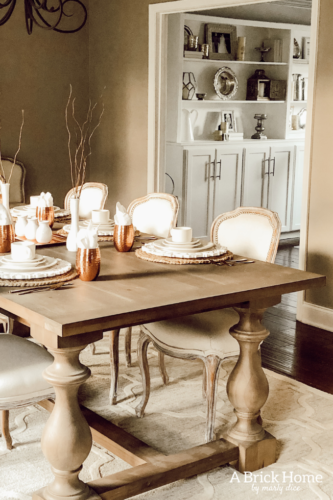LOVING these COPPER decor accents right now. Perfect for winter and paired with wood tones. See how Marly decorates her dining room with copper. #copperdecor