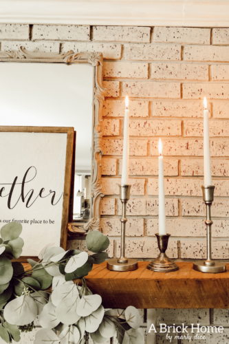 This cozy winter decor in her living room is so inviting! I love the way she styles the fireplace mantel decor. #cozywinterdecor