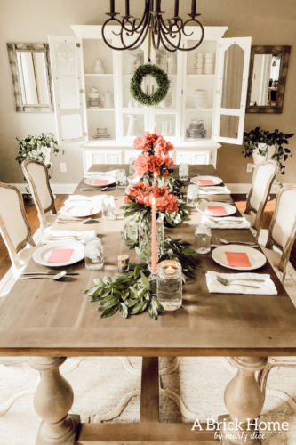 Dreamy spring tablescape using mason jars, candles and flowers! #springtablescape #masonjarideas