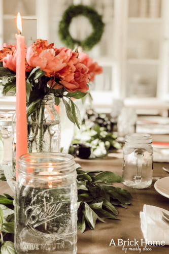 Dreamy spring tablescape using mason jars, candles and flowers! #springtablescape #masonjarideas