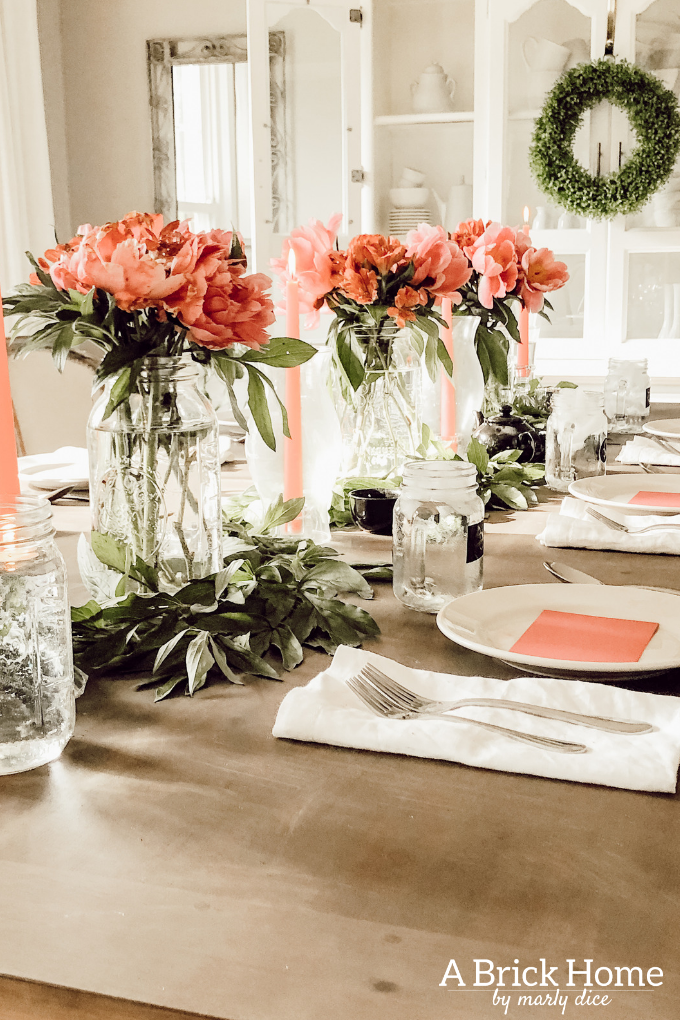 Dreamy spring tablescape using mason jars, candles and flowers! #springtablescape #masonjarideas