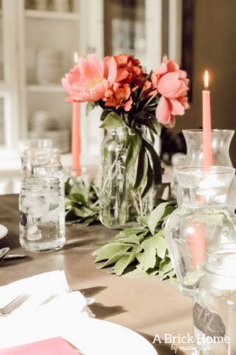 Dreamy spring tablescape using mason jars, candles and flowers! #springtablescape #masonjarideas