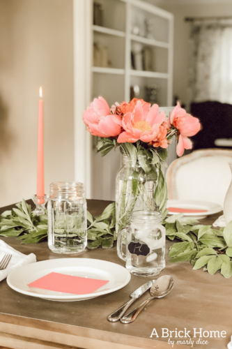 Dreamy spring tablescape using mason jars, candles and flowers! #springtablescape #masonjarideas