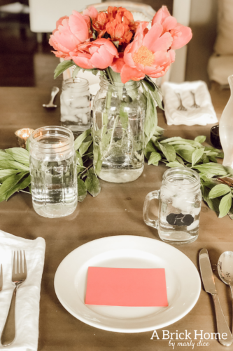 Dreamy spring tablescape using mason jars, candles and flowers! #springtablescape #masonjarideas