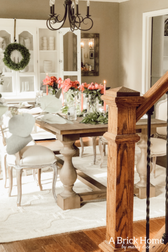 Dreamy spring tablescape using mason jars, candles and flowers! #springtablescape #masonjarideas