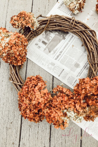 WOAH! This is so beautiful. Learn how to make a budget-friendly DIY fall wreath using hydrangeas from your yard! #diyfallwreath #diywreath