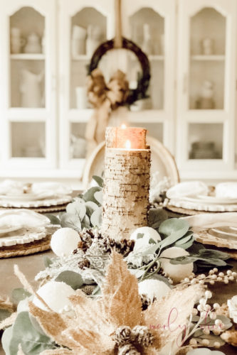 Loving this rustic winter tablescape and winter dining room decor! Beautiful use of eucalyptus and burlap together. #rusticwintertablescape #winterdecor #winterdiningroomdecor