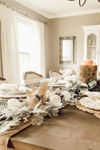Loving this rustic winter tablescape and winter dining room decor! Beautiful use of eucalyptus and burlap together. #rusticwintertablescape #winterdecor #winterdiningroomdecor