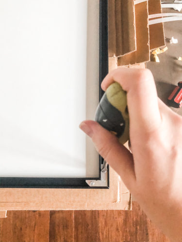Learn how to get a high end look with a custom gallery wall! You'll learn how to decorate a large wall the easy way! #decoratealargewall #gallerywall