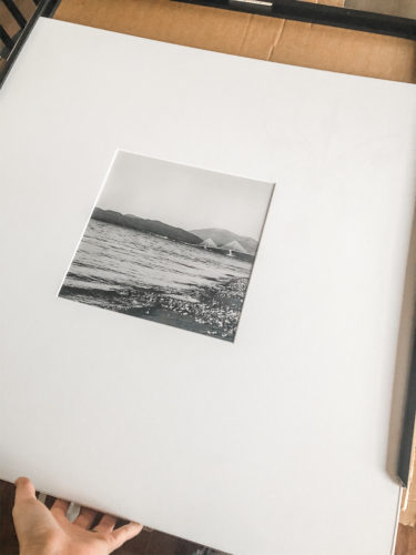 Learn how to get a high end look with a custom gallery wall! You'll learn how to decorate a large wall the easy way! #decoratealargewall #gallerywall